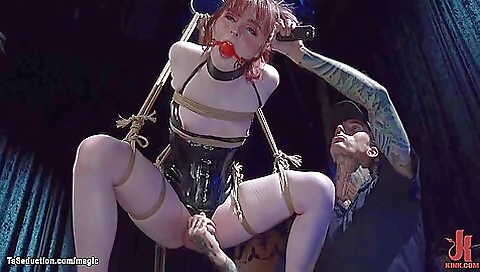 Brunette with a tattooed pussy is tied and hung on a strapon